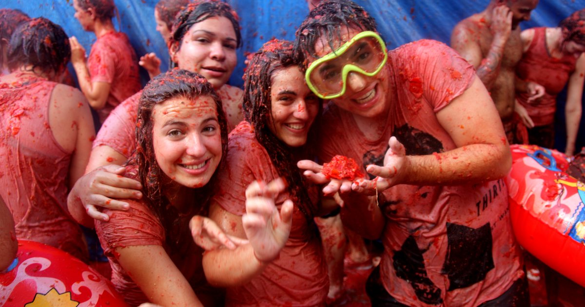 Crowds covered in tomato pulp during La Tomatina, the tomato fight in Bunol near Valencia